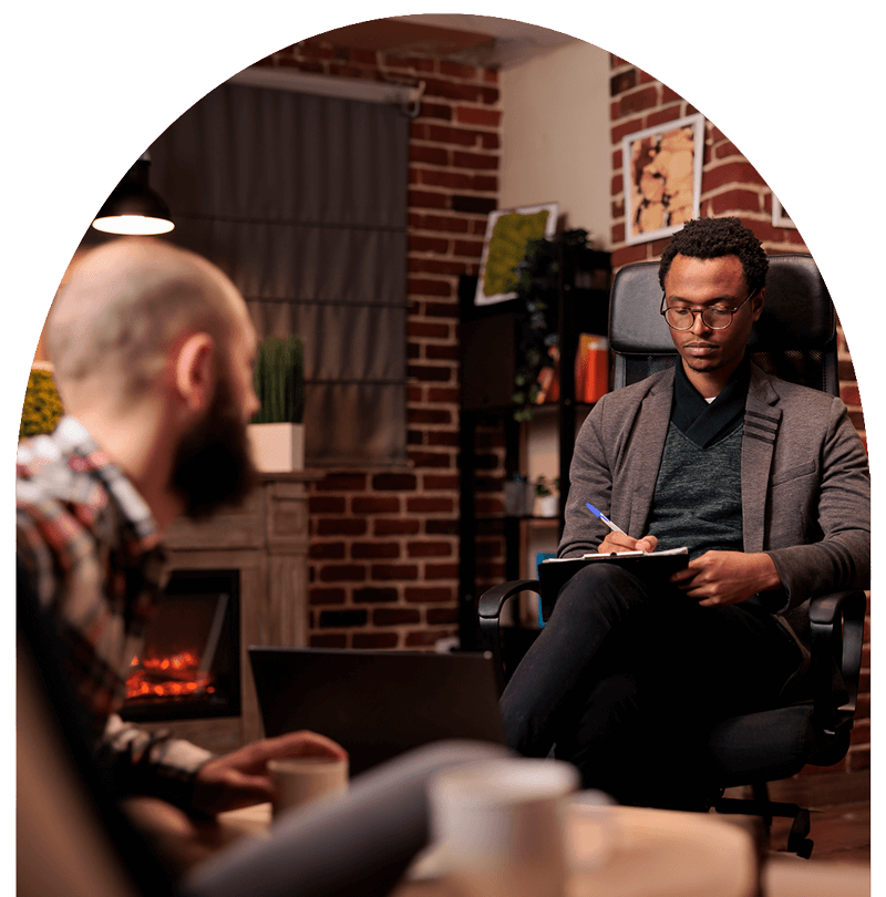 counselor takes notes while talking to client