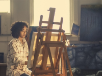 artist paints on easel