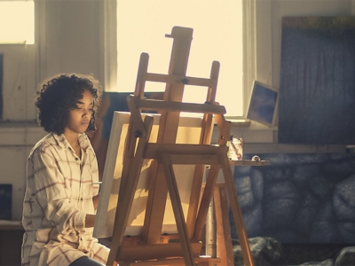 artist paints on easel
