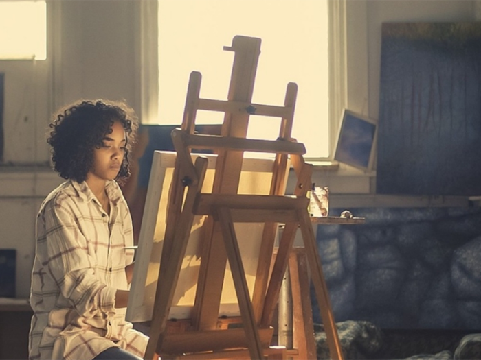 artist paints on easel