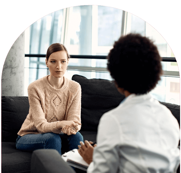 female speaks to counselor in office setting